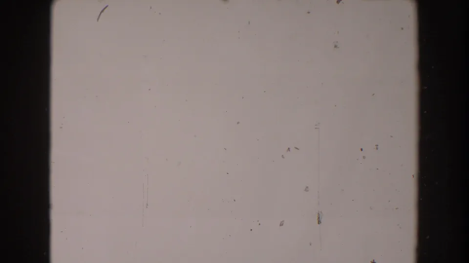 Blank-looking 8mm frame from the supplied 1962 North Hollywood clip, showing film gate edges, dust, and faint scratches.