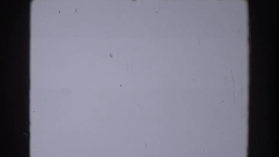 A nearly blank aged 8mm frame follows the yard scene, showing pale exposure, dust, and dark contact-sheet borders.