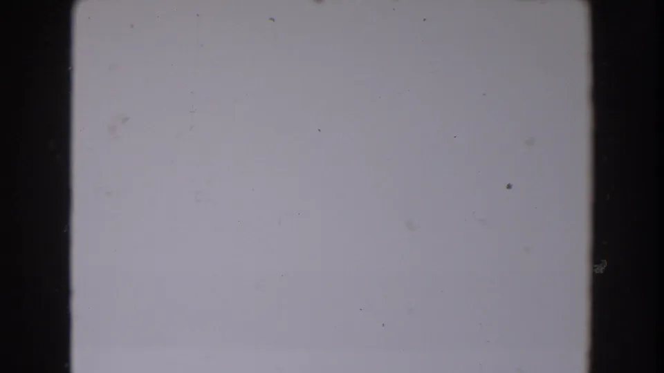 The final extracted frame is nearly blank, with aged-film specks, slight fading, and dark borders from the 8mm scan.