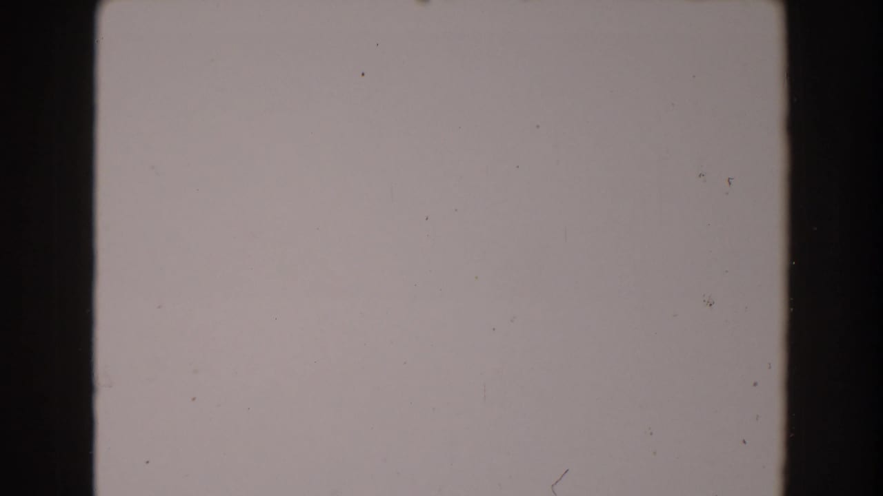 Blank 8mm frame area with a dark vertical strip and scattered dust.