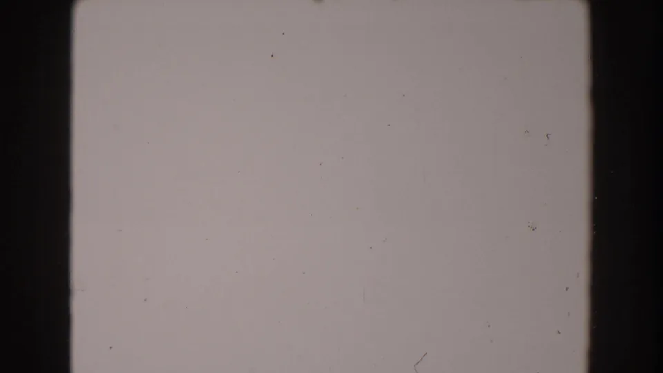 Blank 1962 8mm frame from the North Hollywood reel with a dark vertical strip, pale exposure, dust, and small scratches.