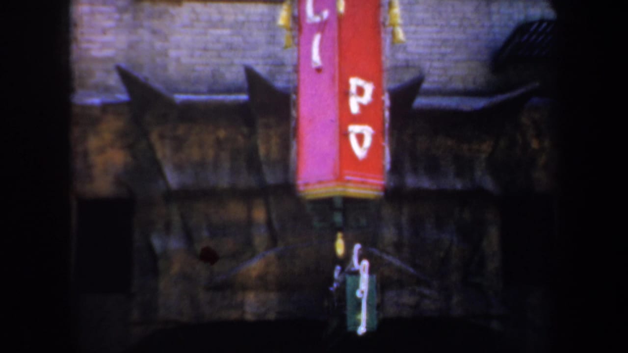 Red vertical sign on a brick facade above a dark arched passage.