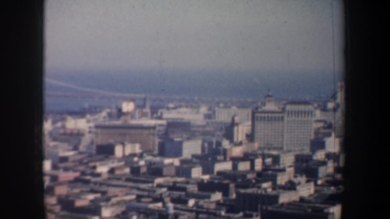 Distant San Francisco skyline with bay water and a partial Bay Bridge view.