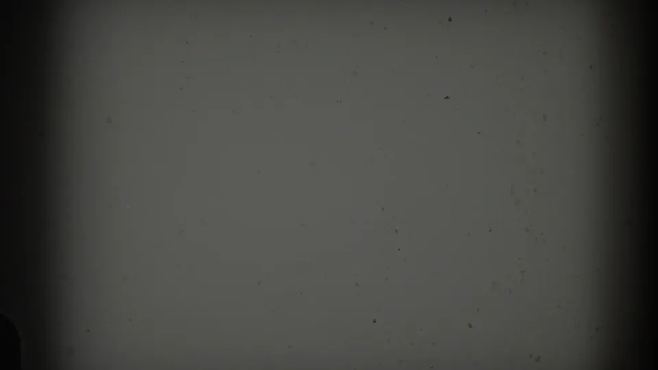 Dark opening frame from 1959 8mm Barcelona footage, showing mostly blank film surface with grain, dust, and gate shadow.