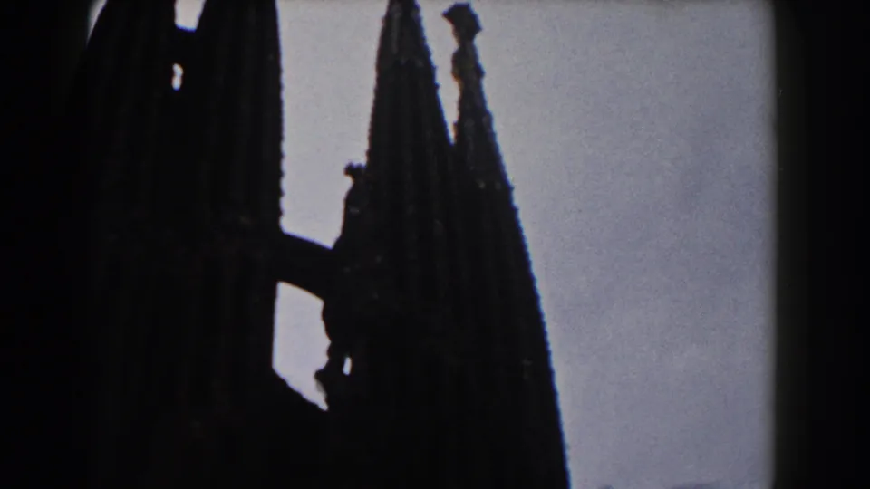1959 Barcelona 8mm frame with clustered Gothic spires silhouetted against the sky.