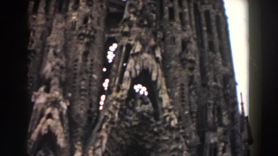 1959 Barcelona 8mm frame showing carved stone arches, clustered facade details, and a soft handheld view of the structure.