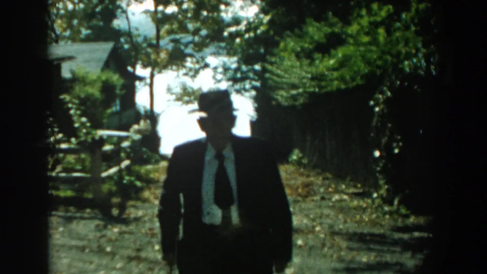 Near the end of the shot, the elderly man approaches in silhouette against a bright Michigan outdoor background.