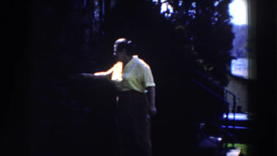 In the final frame, the woman in yellow extends an arm near the hedges, with strong shadow and 8mm grain visible.