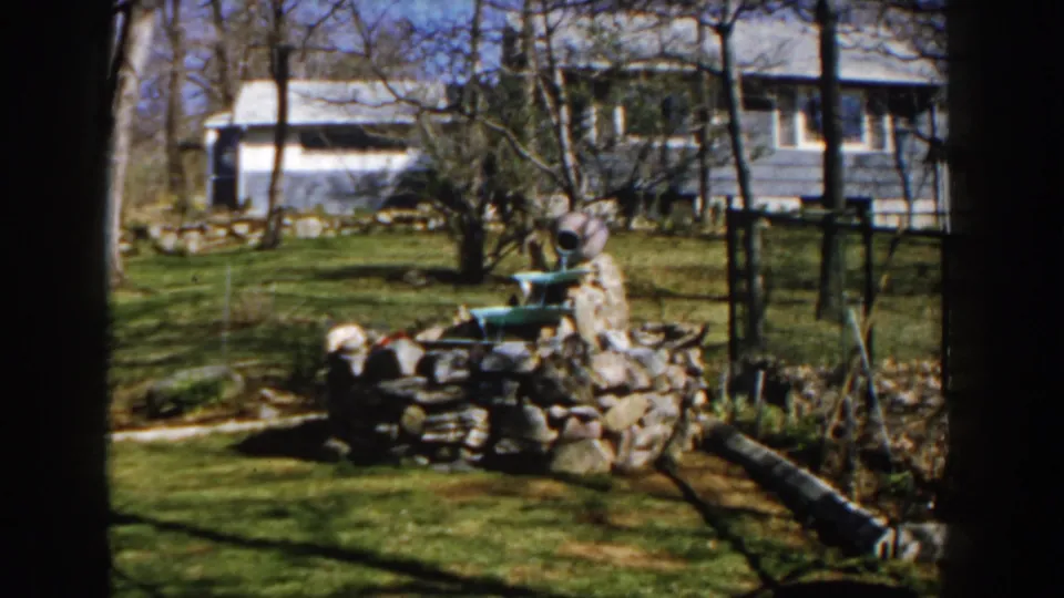 A Michigan backyard scene from 1959 shows the fountain centered against grass, leafless trees, fencing, and a modest house exterior.
