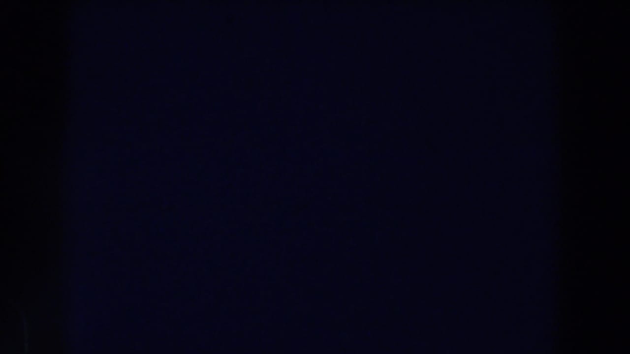Dark frame with a vertical band and faint bluish texture.