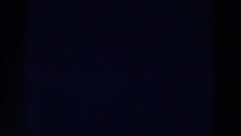 Underexposed 1959 Michigan 8mm frame with a central dark band, blue-black tone, and no identifiable subject.
