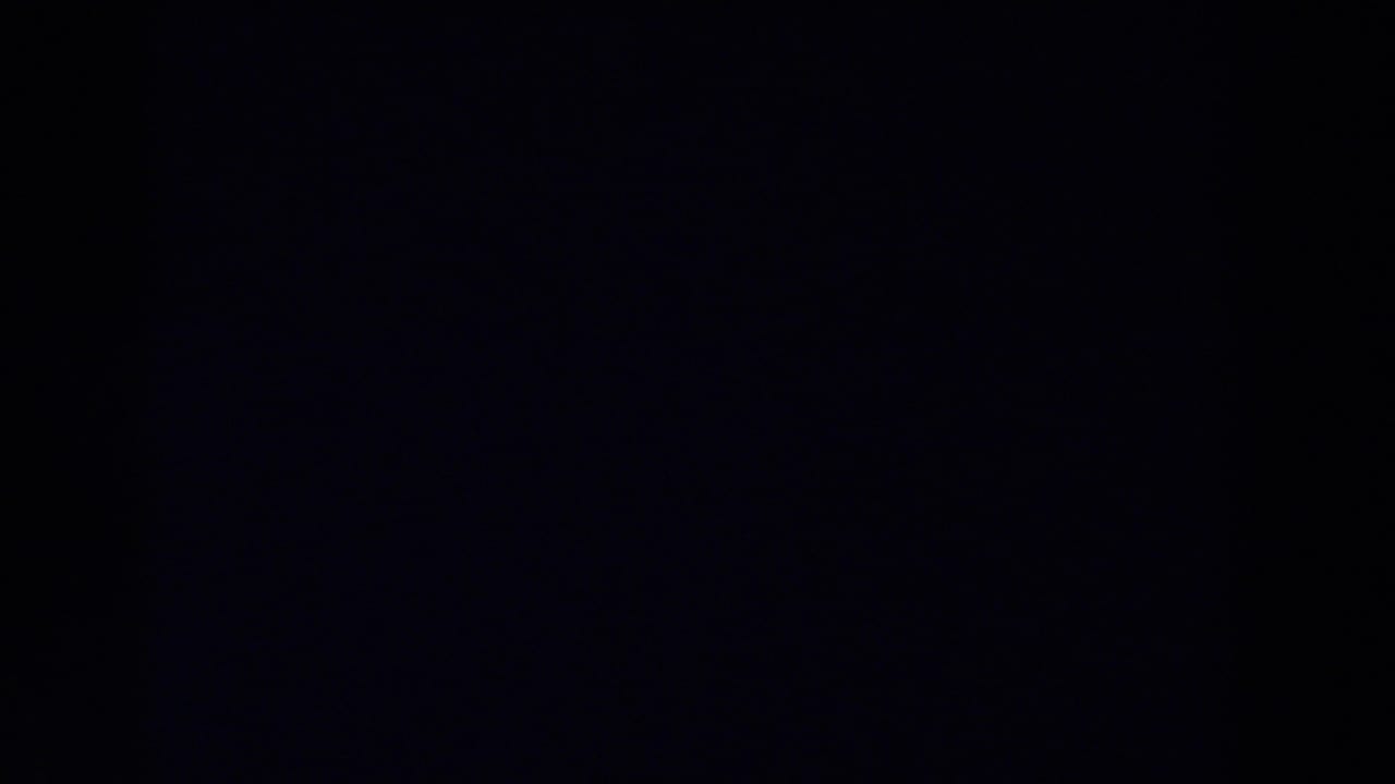 Very dark blue-black frame with a faint vertical shadow and soft grain.