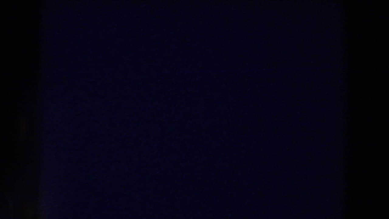 Dark frame with a deep blue area and faint vertical division near the center.