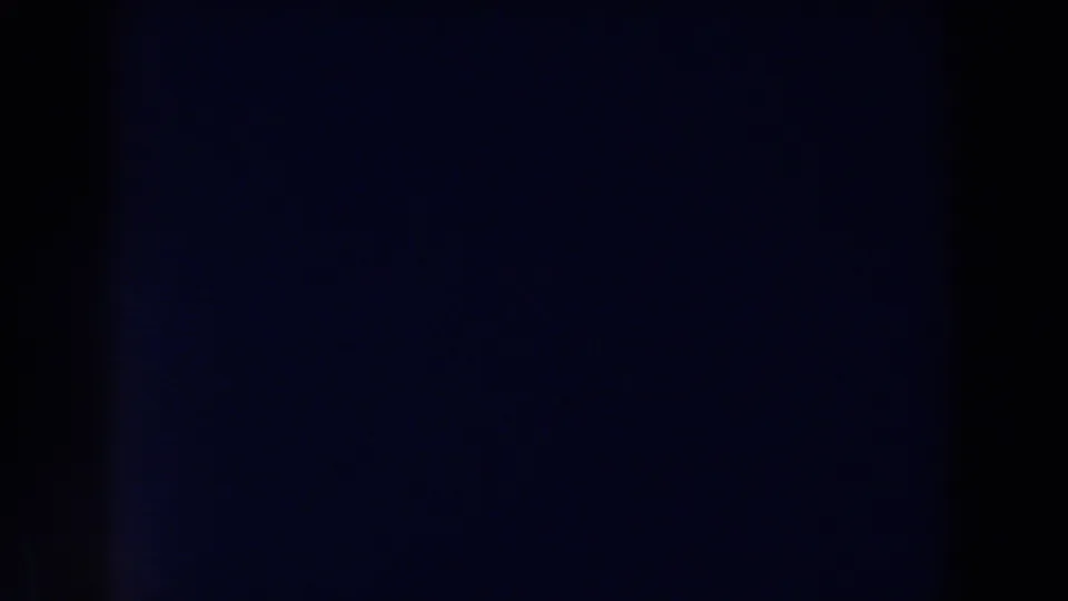 Final low-light 1959 Michigan 8mm frame with faint blue illumination, central shadowing, and grainy film texture.