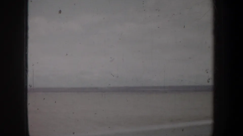 A soft, faded 8mm view of an Oregon horizon, with dark frame borders and surface marks visible across the scan.