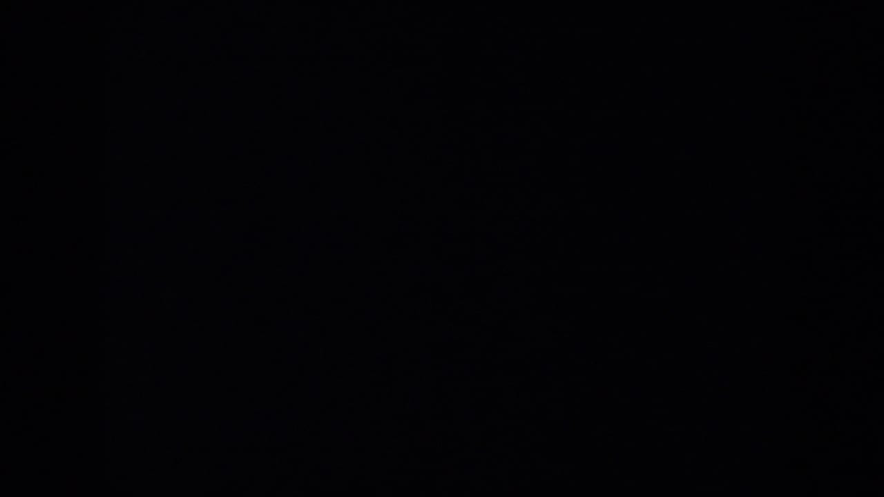 Mostly dark 8mm frame with a small overexposed field area at the right edge.