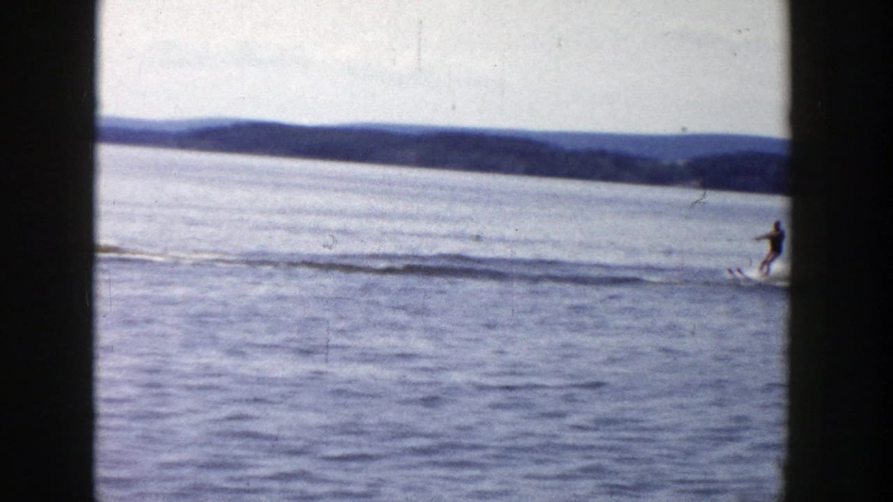At the end of the 1958 Wisconsin lake shot, the skier moves out of frame while wake trails stretch across the water.