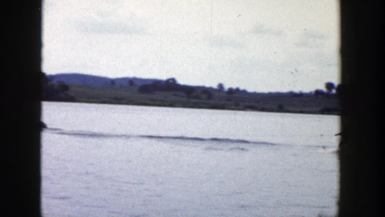 A final 1958 Wisconsin lake frame shows the skier mostly out of view, leaving a long wake across calm water.