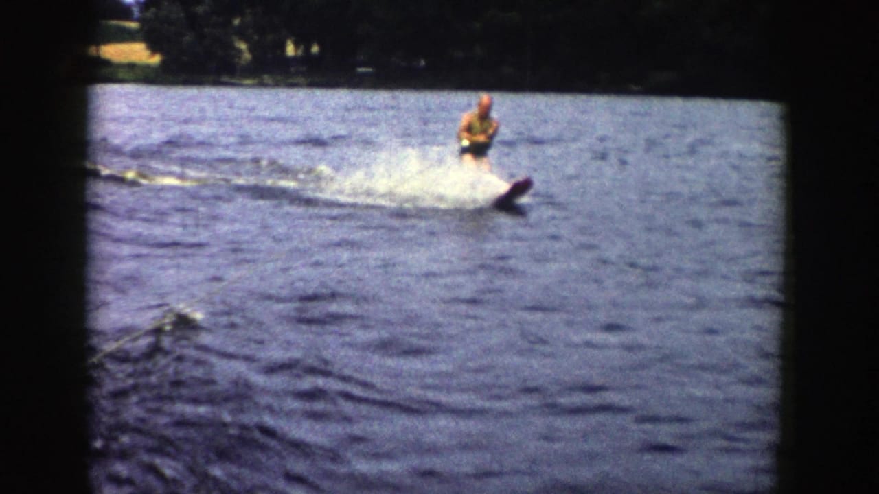 The skier continues across the Wisconsin lake, framed by rounded 8mm borders and rippled blue water.