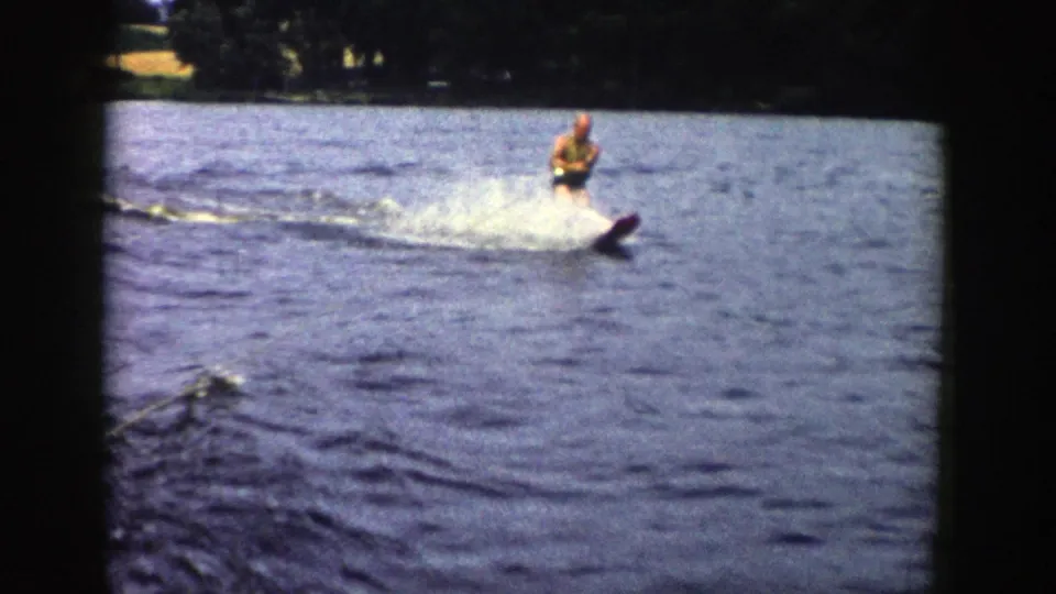 The skier continues across the Wisconsin lake, framed by rounded 8mm borders and rippled blue water.
