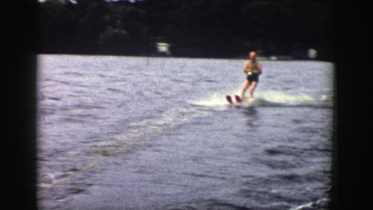 The final frame shows the skier gliding across the lake to the right, with a bright wake and wooded Wisconsin shoreline behind.