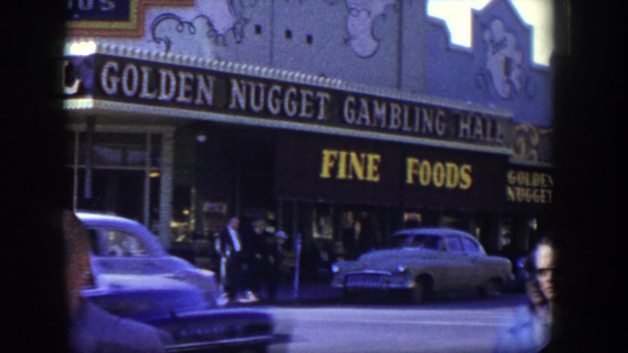 Golden Nugget Gambling Hall frontage with Fine Foods signage, pedestrians, and cars on the street.