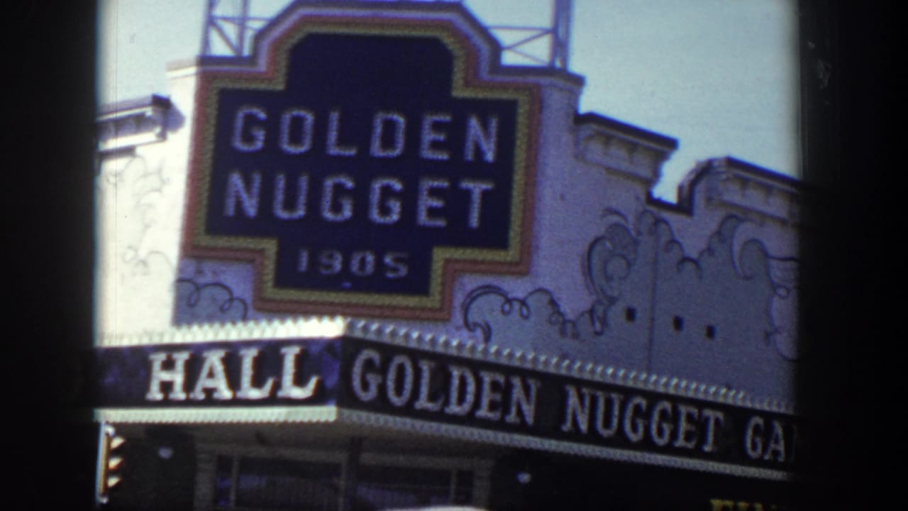Close view of the Golden Nugget sign above a casino awning, with dark film border at left.