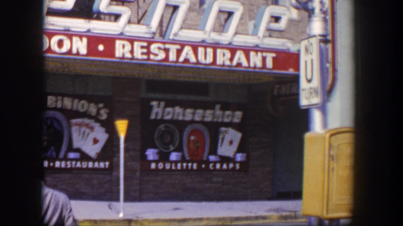 Benny Binion's Horseshoe signage above a Las Vegas storefront, with part of a man at the lower left.