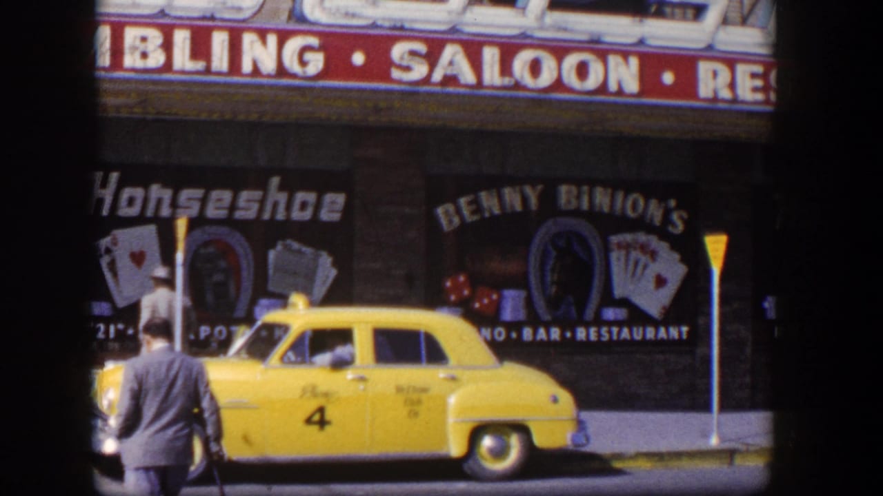 Yellow taxi parked outside Horseshoe and Benny Binion's gambling saloon signage with men nearby.