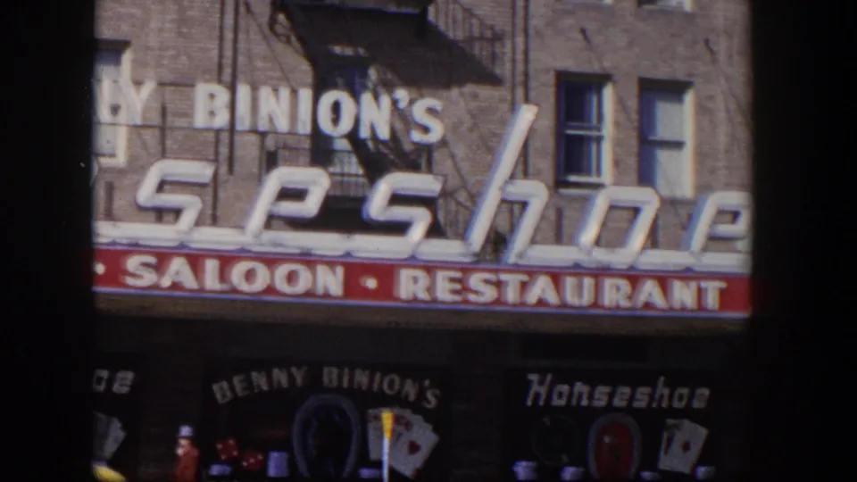 1954 Las Vegas close framing of Benny Binion's Horseshoe signage above the saloon and restaurant storefront.