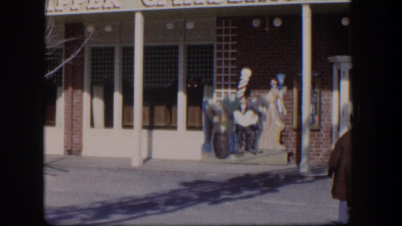 Clipper Gambling Hall storefront with columns, sign, sidewalk, and display figures near the entrance.