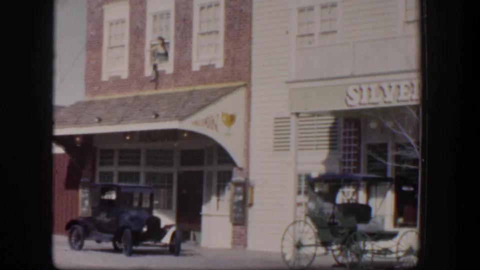 1954 Las Vegas view of a saloon-style storefront with an early automobile, carriage, Silver Slipper lettering, and sidewalk frontage.