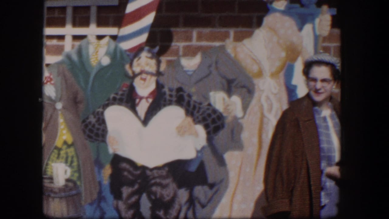 Painted barber-shop character and suits on a wall appear beside the woman at frame edge.