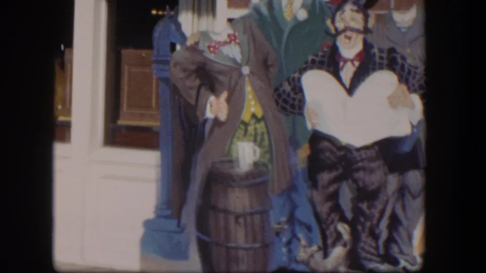 The final frame shows the mural's barber character and surrounding painted clothing near a storefront entrance in Las Vegas home-movie footage.