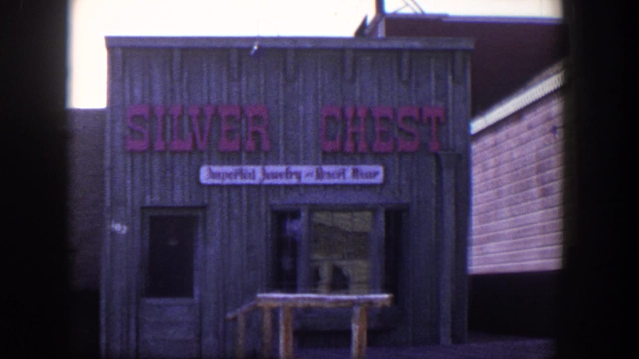 1954 Las Vegas 8mm frame showing the Silver Chest shop facade with a pink sign and smaller imported jewelry and resort wear banner.