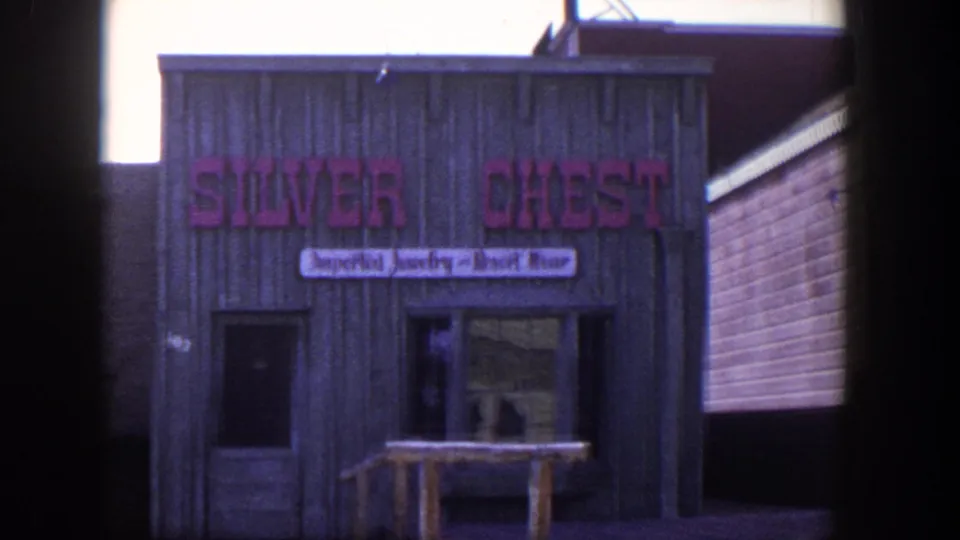 1954 Las Vegas 8mm frame showing the Silver Chest shop facade with a pink sign and smaller imported jewelry and resort wear banner.