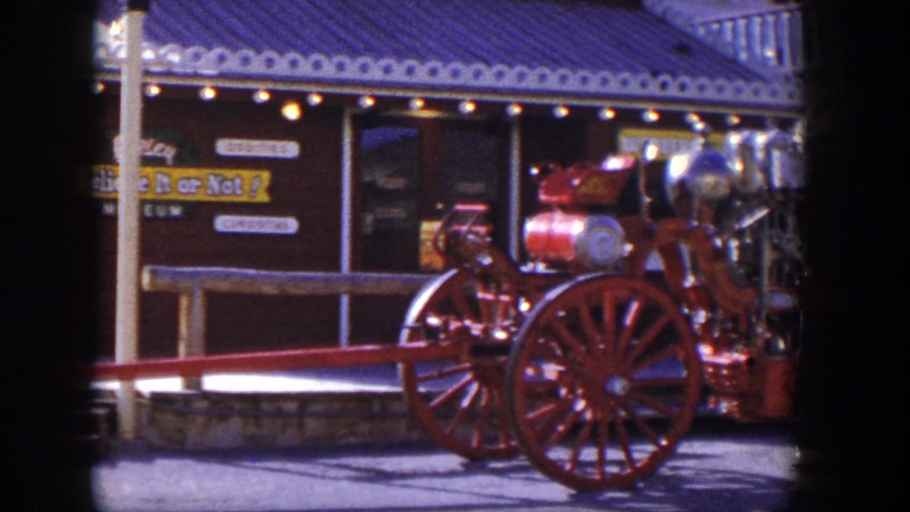 Side view of the red fire engine with museum signage behind it.