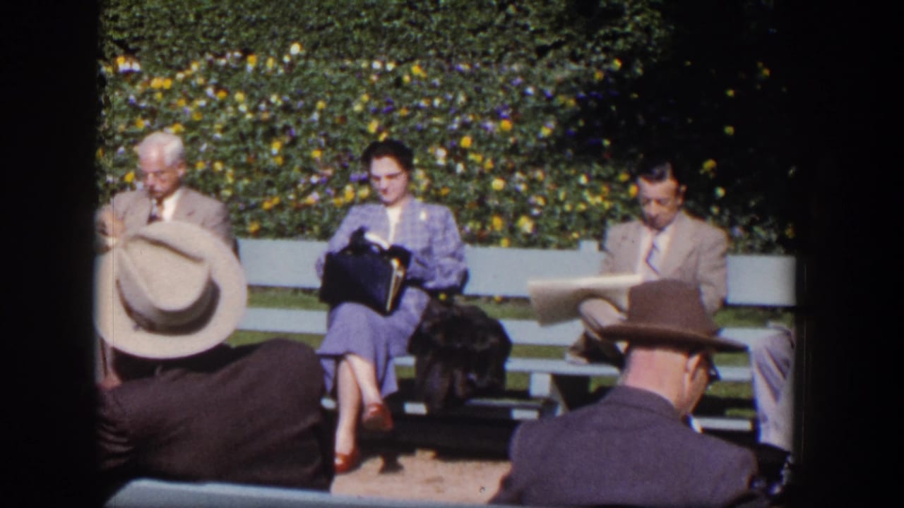 Adults remain seated on benches while a woman reads and a man looks down at a newspaper.