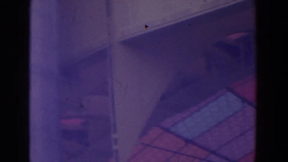 Soft 8mm frame showing a roofline or overhang with nearby red and blue gridded canopy panels.