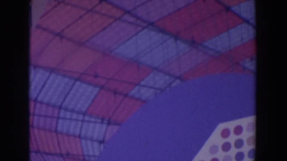 Close view of a geometric gridded canopy or roof element with red and blue sections against a purple-blue background.