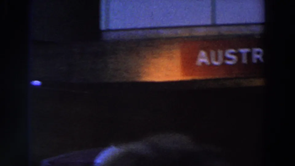 The final frame shows partial Austrian Restaurant lettering and silhouetted crowd forms under blue and orange nighttime lighting.