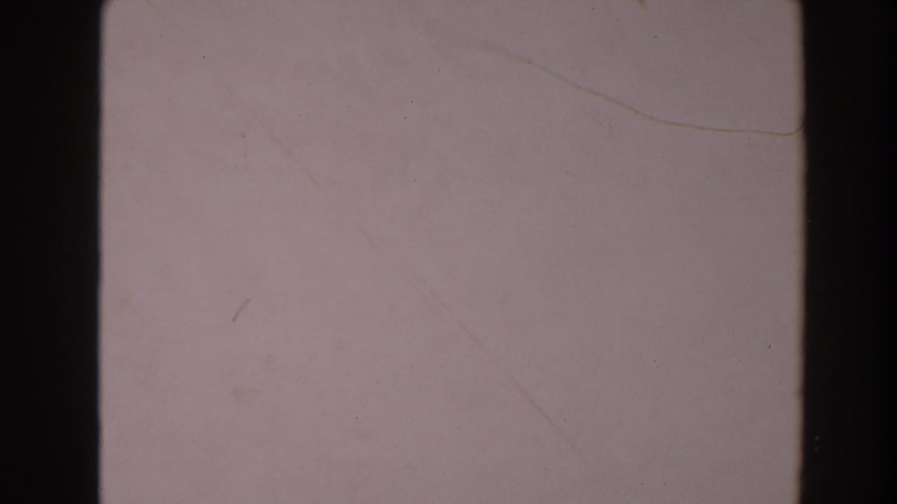 Plain pale concrete surface with dark vertical film borders.