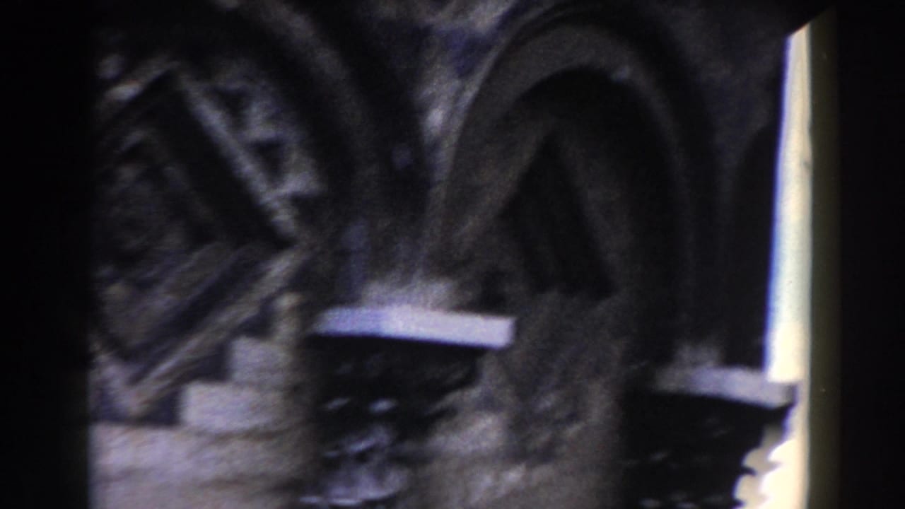 Circular carved stonework and arched architectural details in soft focus.