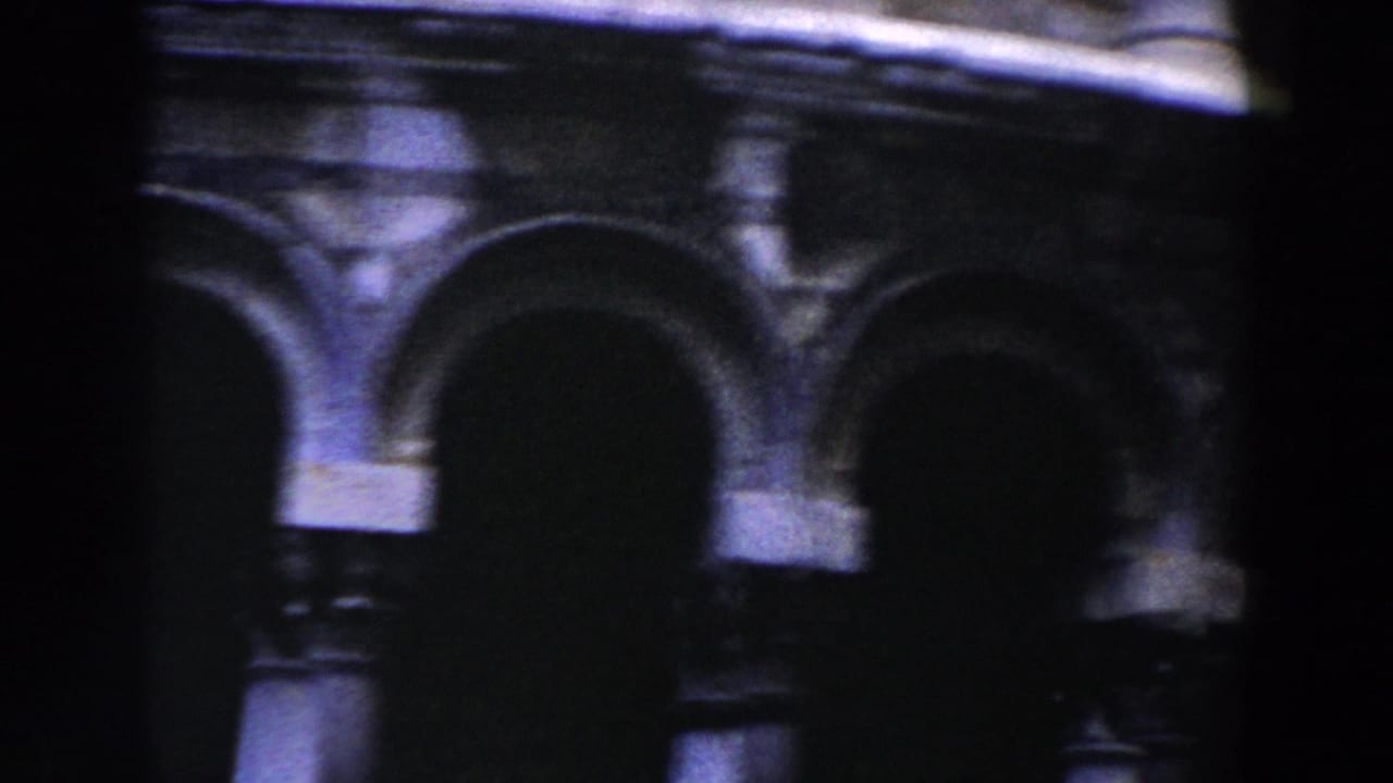 Close view of arched stone galleries on the Leaning Tower of Pisa.