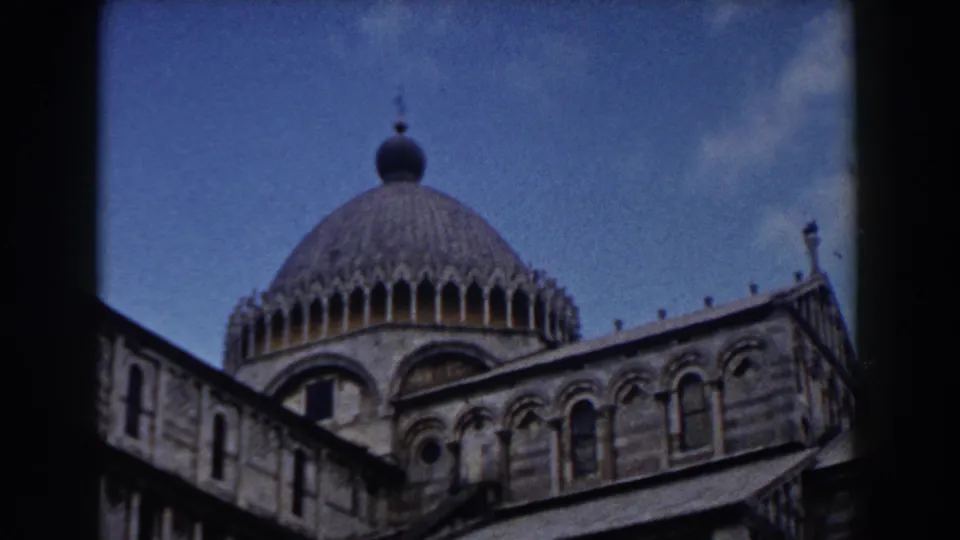 1959 Pisa Cathedral frame showing the dome and arched facade in a handheld 8mm travel view.