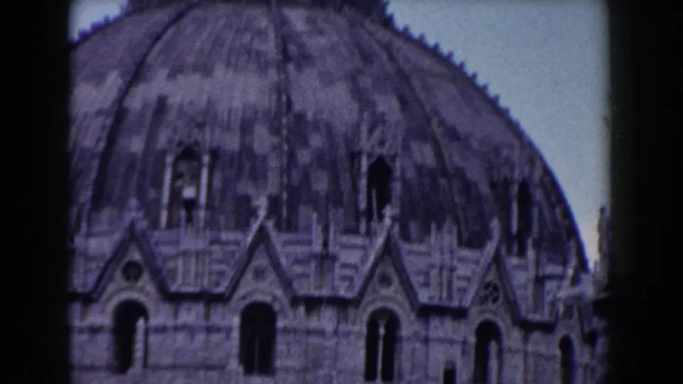 Close 8mm view in Pisa showing a weathered dome, arched openings, and ornate stone detail.