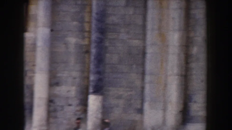 In the final Pisa frame, two distant men walk near massive stone columns and wall sections, giving scale to the landmark architecture.
