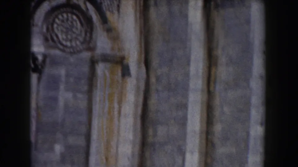 1959 Pisa cathedral exterior footage showing a circular rose window, arched stonework, and weathered facade details.