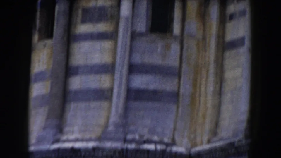 Pisa cathedral wall details in 1959 8mm footage, with striped masonry, slender columns, and shadowed arched openings.