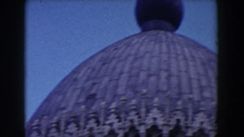 1959 8mm Pisa footage showing a close, soft-focus view of a ribbed historic church dome against blue sky.